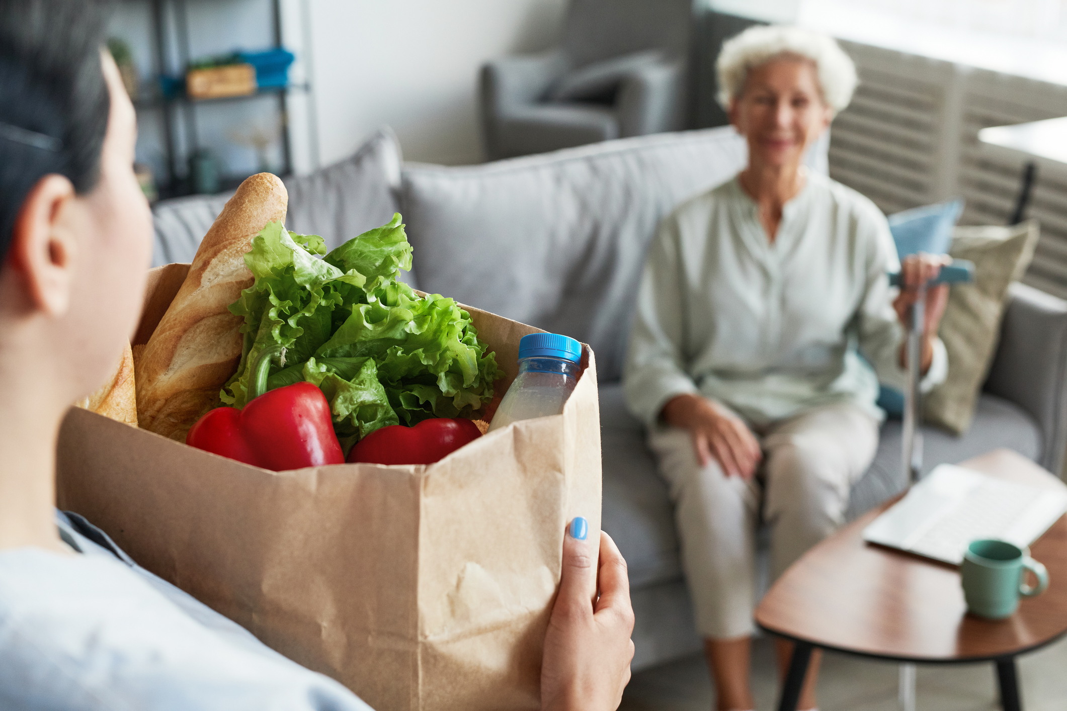 person dropping groceries off home care