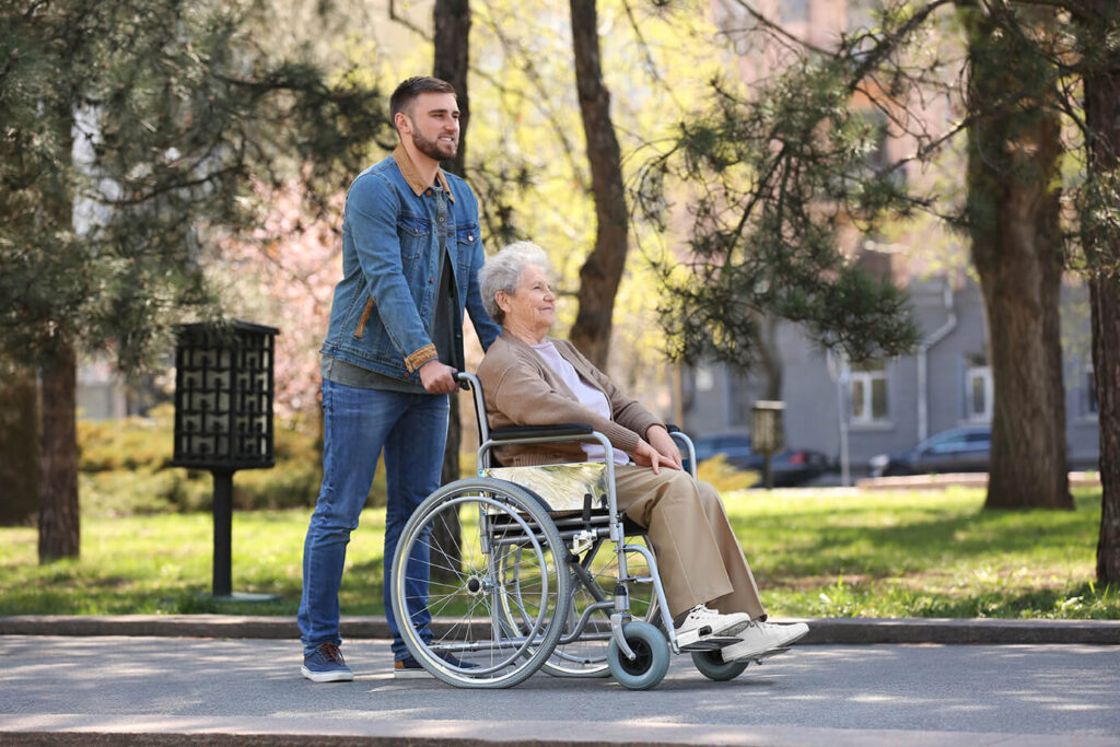 Caregiver taking elderly patient out to experience life after a stoke
