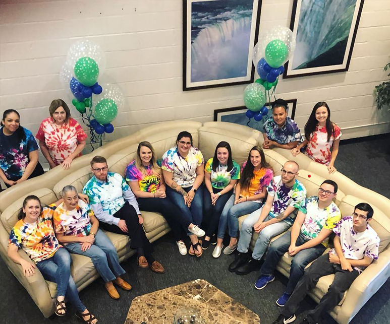 Venture Forthe Niagara Falls staff members seated around a white couch